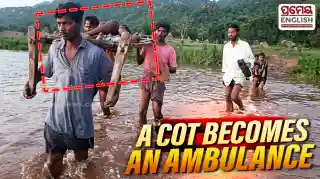 A cot becomes an ambulance: Villagers cross swollen Nagabali River with patient