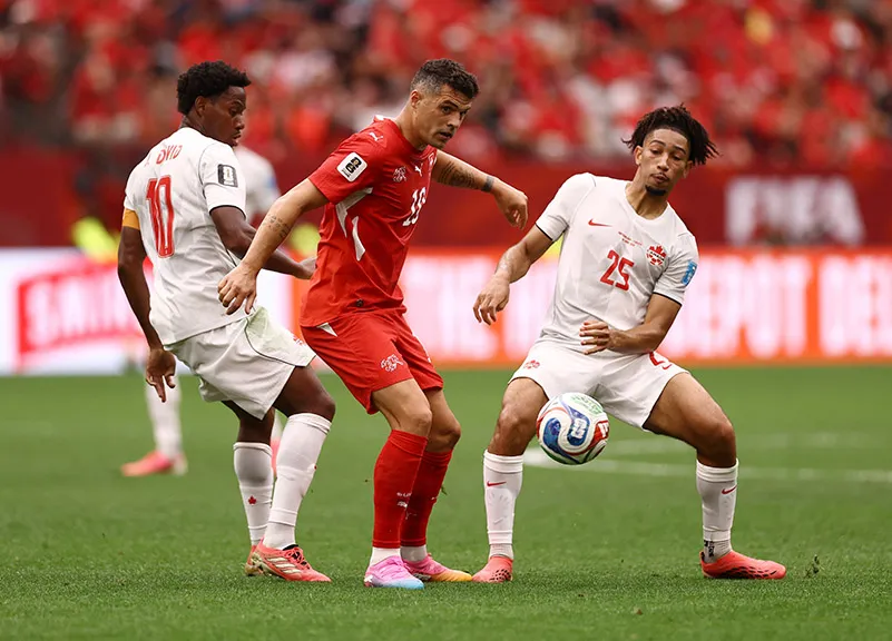 Swiss victory clinches top spot while Canada makes history