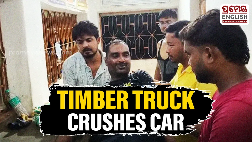 Timber-laden truck overturns onto car in Mayurbhanj Ghat road mishap; driver critically injured
