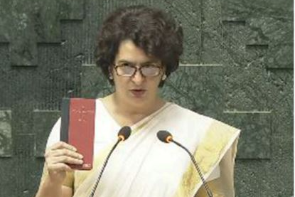 Congress leader Priyanka Gandhi Vadra takes oath as Lok Sabha MP holding a copy of Constitution